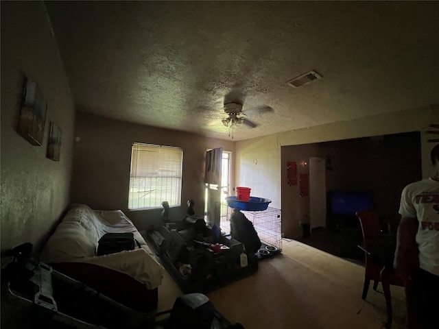 bedroom with visible vents, ceiling fan, and a textured ceiling