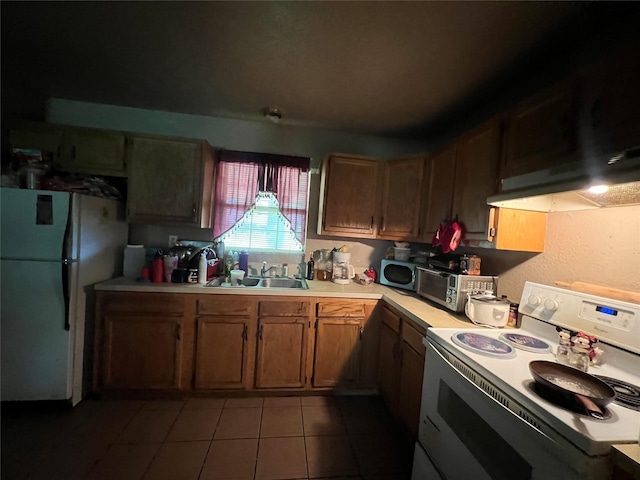 kitchen with white appliances, a toaster, light tile patterned floors, light countertops, and a sink