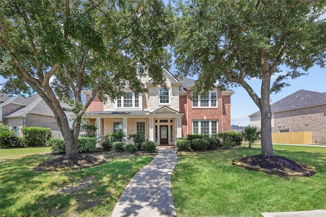 traditional-style home with a front lawn and brick siding