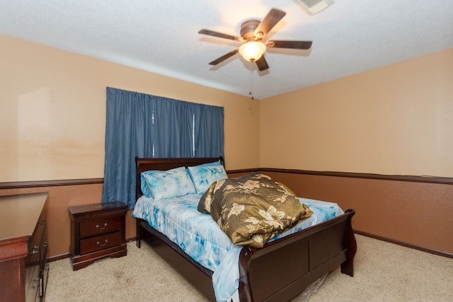 bedroom with ceiling fan and light carpet