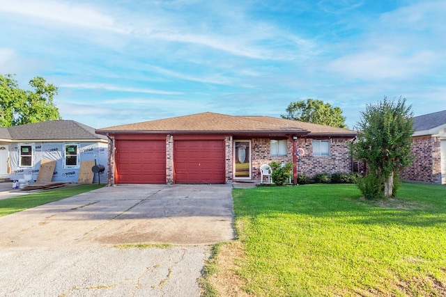 single story home with a front lawn and a garage