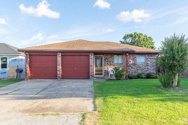 view of front of property with a front yard and a garage