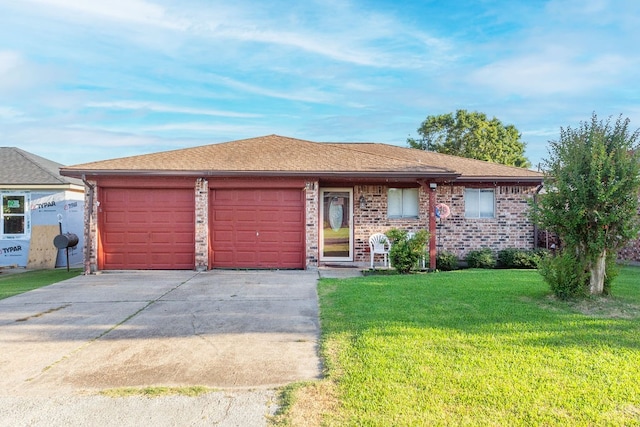 single story home featuring a front lawn and a garage