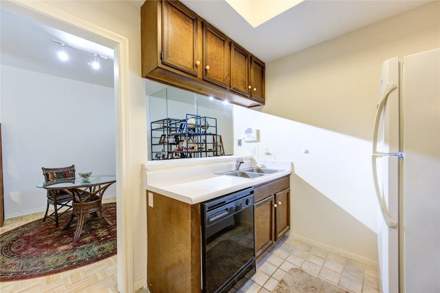 kitchen with dishwasher, light tile patterned floors, sink, and white fridge