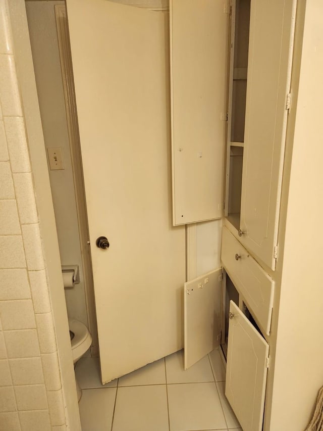 bathroom with tile patterned floors and toilet