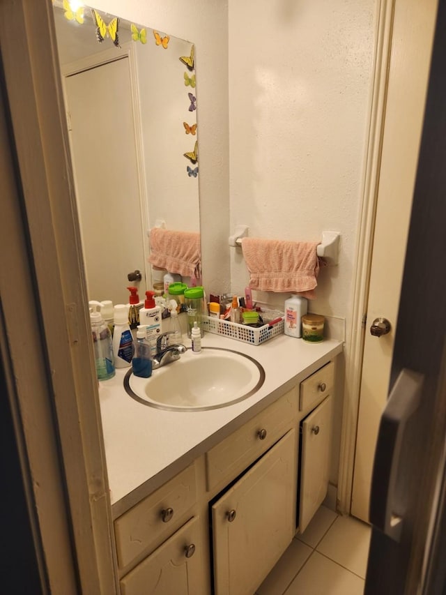 bathroom with tile patterned floors and vanity