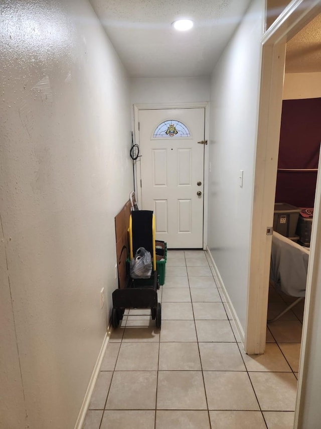 doorway with light tile patterned floors