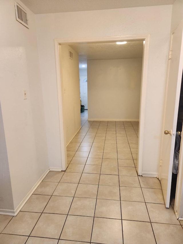 hallway featuring light tile patterned flooring