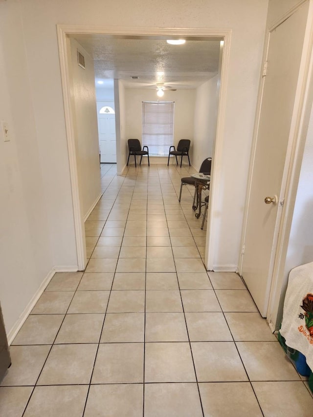 235 W Tri Oaks Ln Unit 235, Houston, TX 77043 - corridor featuring light tile patterned floors and baseboards