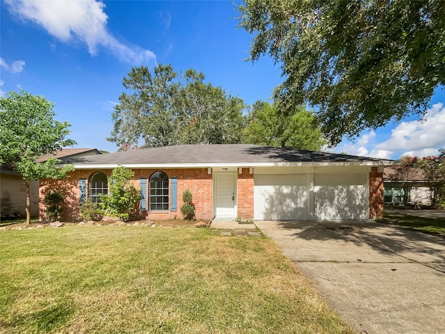 ranch-style house featuring a garage and a front yard