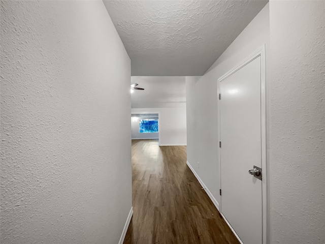 hall featuring hardwood / wood-style floors and a textured ceiling