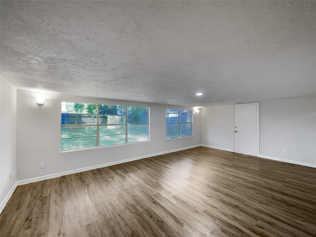 spare room featuring a textured ceiling and hardwood / wood-style floors