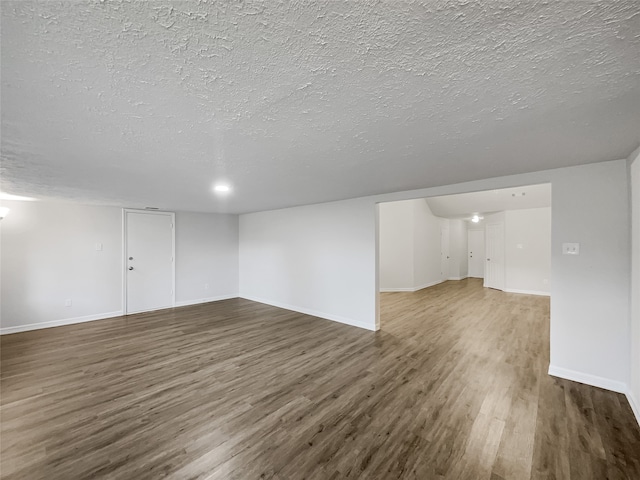 interior space featuring hardwood / wood-style flooring and a textured ceiling