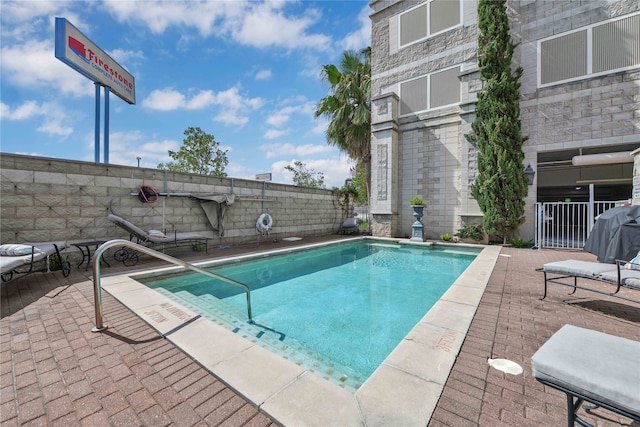 view of swimming pool with a patio area