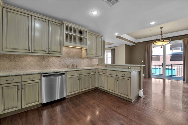 kitchen with dishwasher, dark hardwood / wood-style floors, plenty of natural light, a raised ceiling, and kitchen peninsula