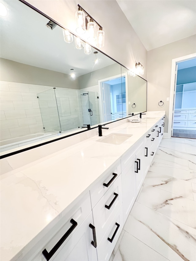 bathroom featuring tile patterned floors, an enclosed shower, and double vanity