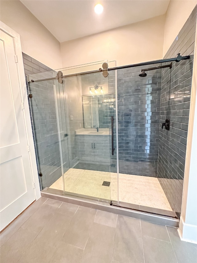 bathroom with tile patterned floors and walk in shower