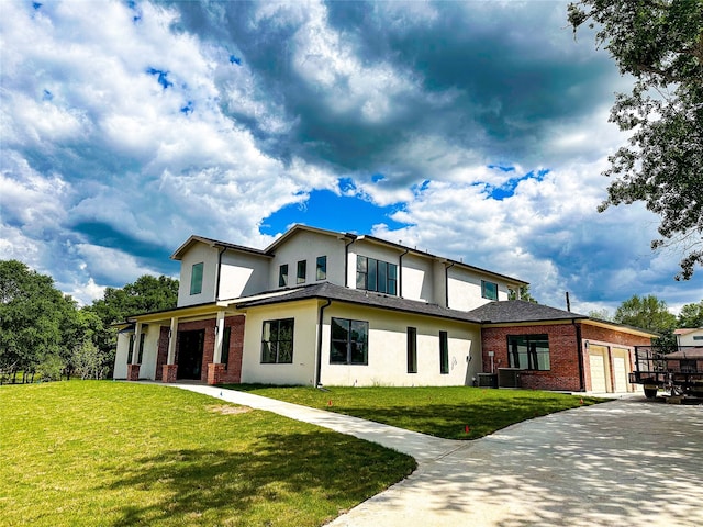 view of front facade with a garage, a front lawn, and cooling unit