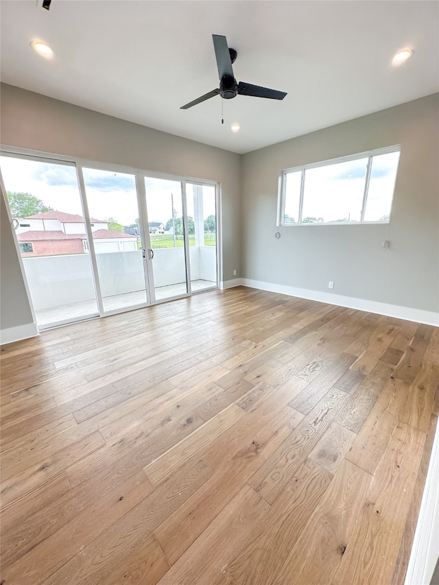 unfurnished room with ceiling fan and light wood-type flooring