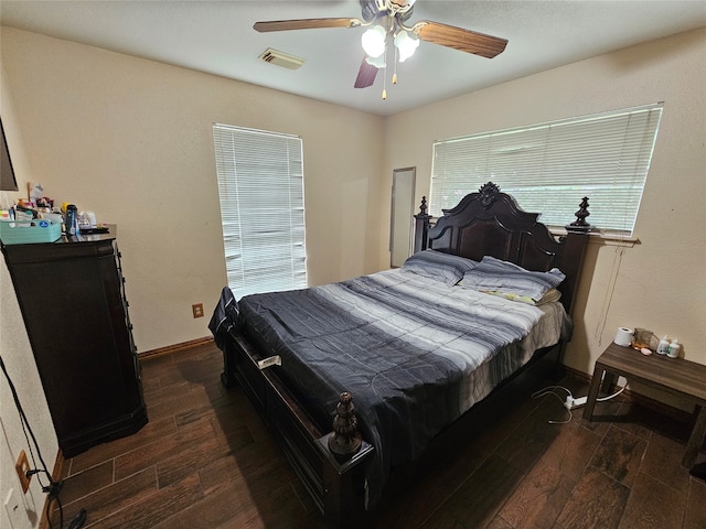 bedroom with ceiling fan and dark hardwood / wood-style flooring