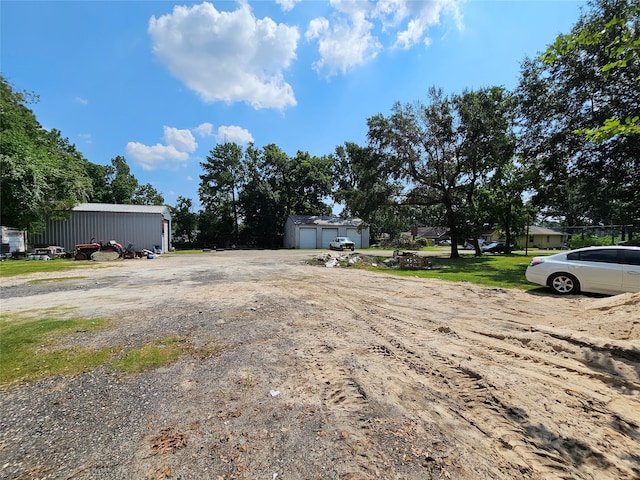 view of yard featuring an outbuilding and a garage