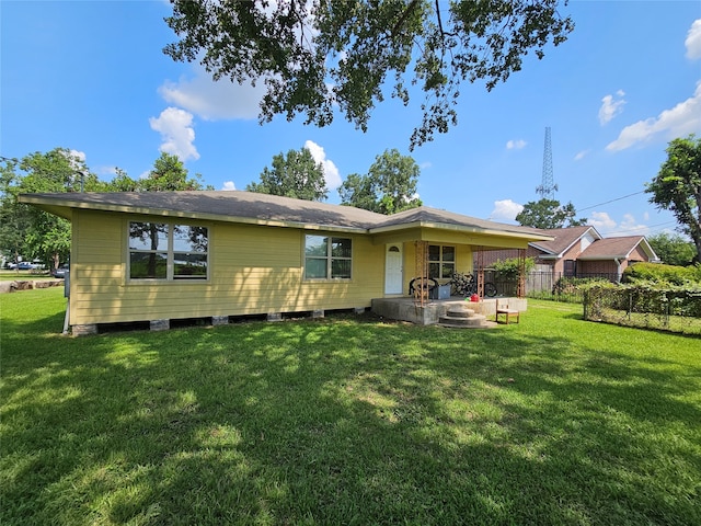 back of house with a lawn