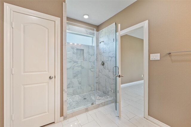 bathroom with tile patterned floors and a shower with shower door