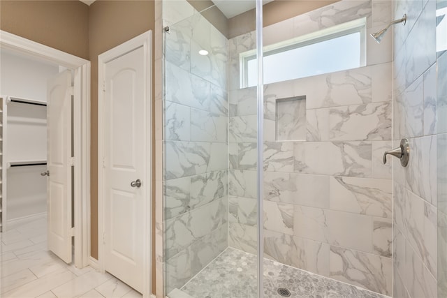 bathroom featuring tile patterned floors and a shower with door