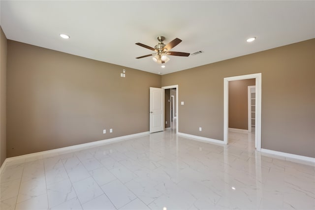 spare room featuring ceiling fan and light tile patterned floors