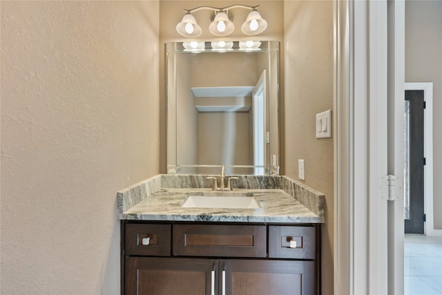 bathroom with tile patterned floors and vanity