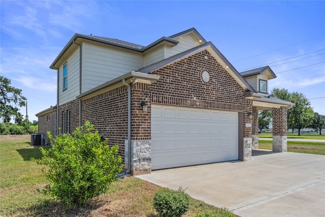 view of home's exterior with central AC unit and a garage