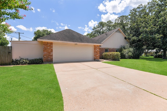 view of front of house with a garage and a front lawn