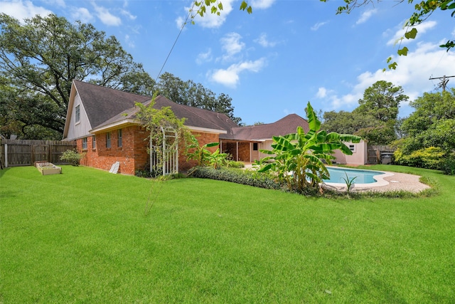 view of yard with a fenced in pool