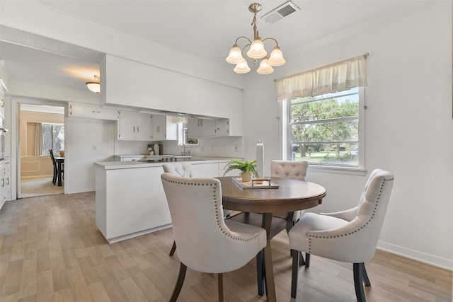 dining room featuring an inviting chandelier and light hardwood / wood-style flooring