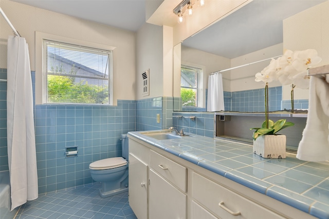 full bathroom with tile walls, tile patterned flooring, toilet, and vanity