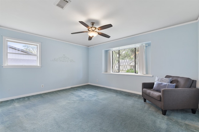 sitting room featuring crown molding, a healthy amount of sunlight, ceiling fan, and carpet flooring