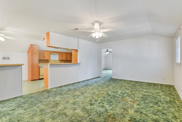 unfurnished living room with ceiling fan, light carpet, and vaulted ceiling