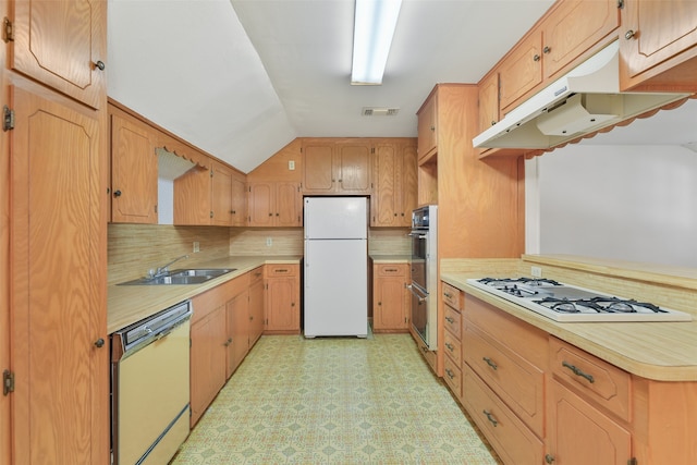 kitchen featuring backsplash, white appliances, sink, lofted ceiling, and light tile patterned flooring