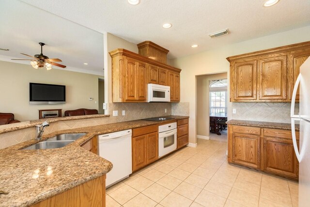 kitchen with sink, decorative backsplash, white appliances, and ceiling fan