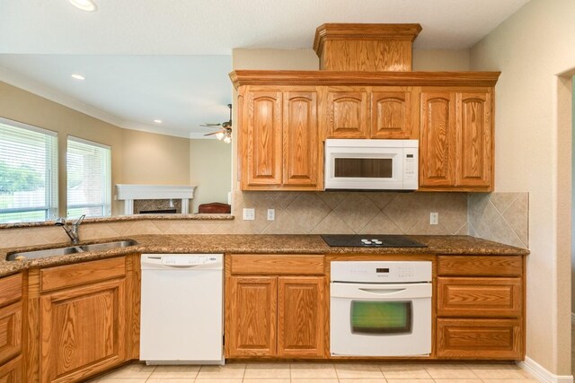 kitchen with decorative backsplash, sink, crown molding, white appliances, and ceiling fan