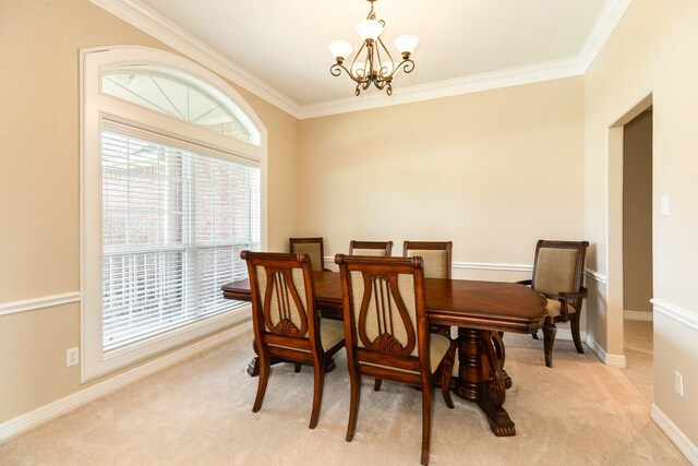 carpeted dining space featuring a chandelier and ornamental molding