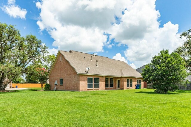 rear view of house with a yard