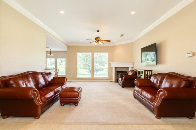 carpeted living room with ceiling fan and ornamental molding