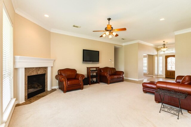 living room with ceiling fan, crown molding, and carpet