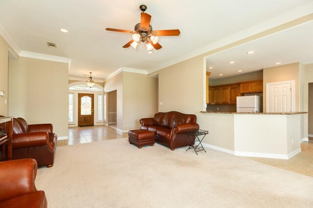 living room featuring ceiling fan, ornamental molding, and light carpet