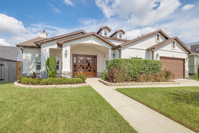 view of front of home with a front lawn and a garage