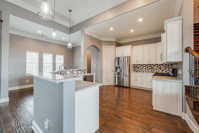 kitchen featuring backsplash, appliances with stainless steel finishes, dark wood-type flooring, white cabinetry, and pendant lighting