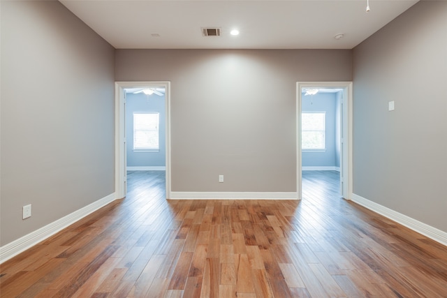 unfurnished room featuring hardwood / wood-style floors and a wealth of natural light