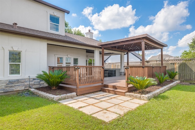 back of house featuring a pergola, a wooden deck, and a lawn