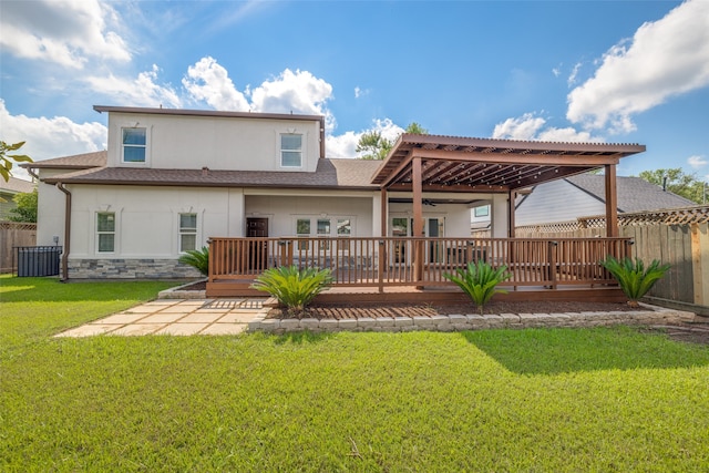 back of house featuring a lawn, a deck, a pergola, and a patio